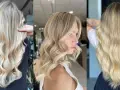 Capelli lunghi e ondulati con sfumature biondo platino, un look radioso e luminoso.