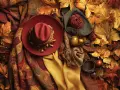 Cappello rosso, sciarpe, gomitolo e foglie autunnali creano un'atmosfera con **colori caldi**.