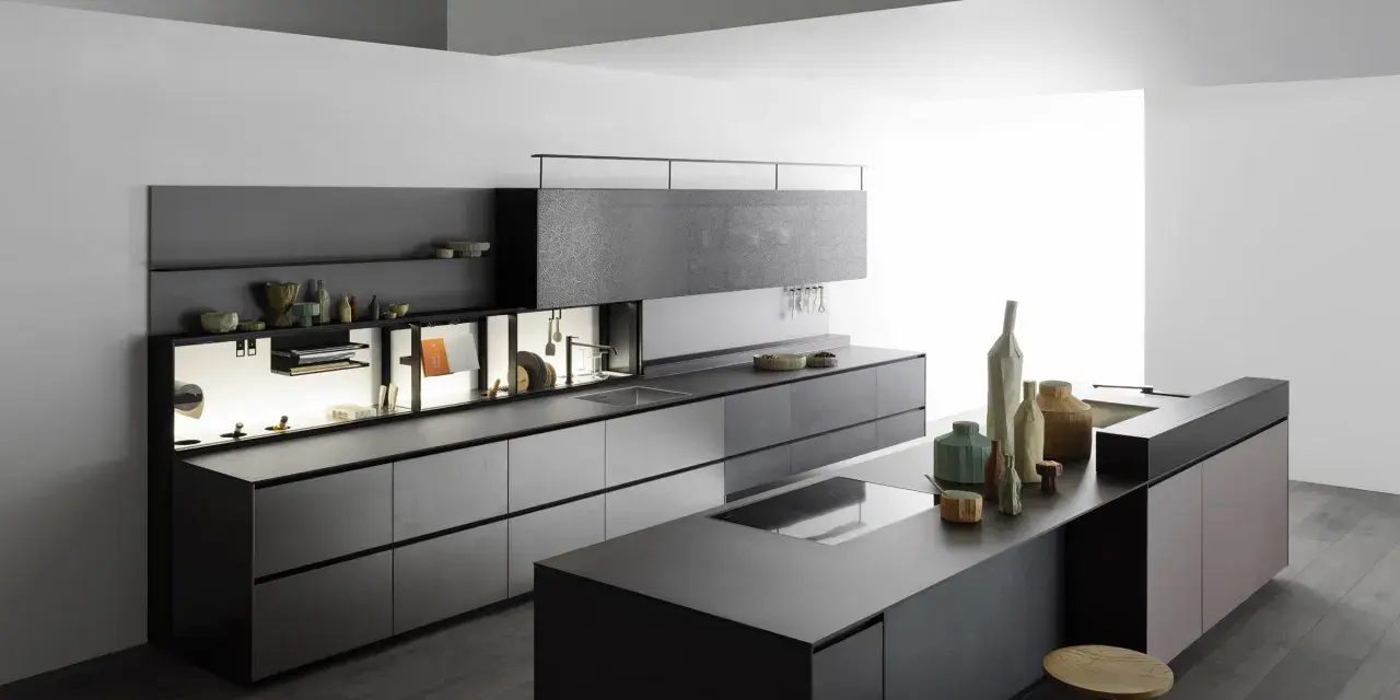 Cucina moderna con isola centrale, pensili a scomparsa e finiture in pietra. Un esempio di come progettare una cucina funzionale ed elegante.