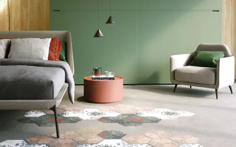 Camera da letto con pareti verde foresta, letto comodo, poltrona e un tappeto esagonale decorato.