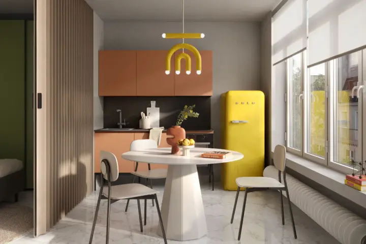 Un'elegante cucina e camera da letto insieme, con un frigorifero giallo acceso, mobili color pesca e una divisoria in legno.