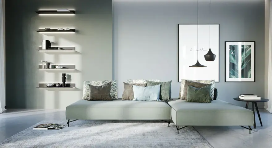 Soggiorno di una casa moderna con divano angolare, quadri e mensole illuminate.
