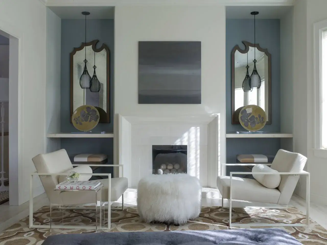 Elegante nicchia nel muro salotto con specchi antichi, lampade moderne e sedie in pelle.