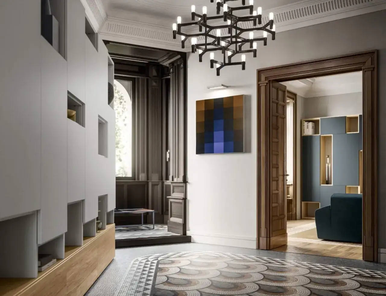 Interni in case stile Liberty: un corridoio con armadi moderni, un quadro astratto e un'elegante porta in legno che si apre su un salotto con divano blu.