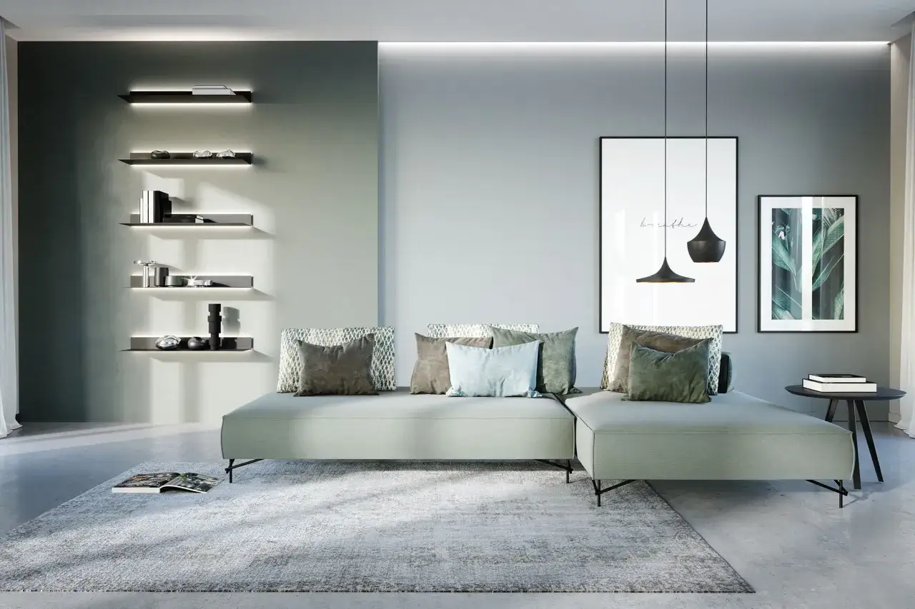 Soggiorno di una casa moderna con divano angolare, tappeto, quadri e mensole illuminate.